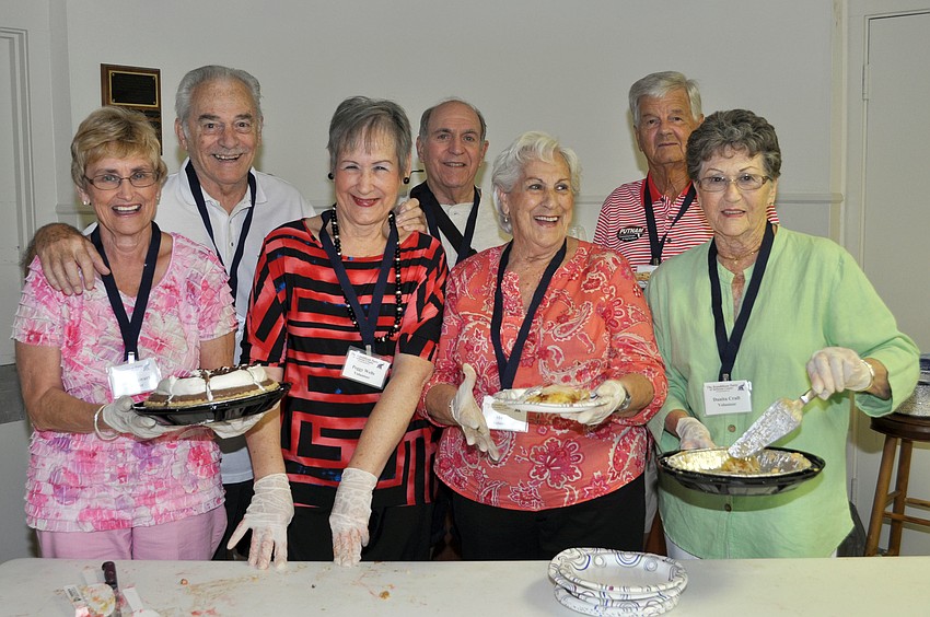 Sandy Stewart, Roy and Peggy Wells, Don Stewart, Marie Padantonio, Franklin Curcillo and Mita Craft from the VillageWalk Republican Club serve Yoderâ€™s pies to guests.