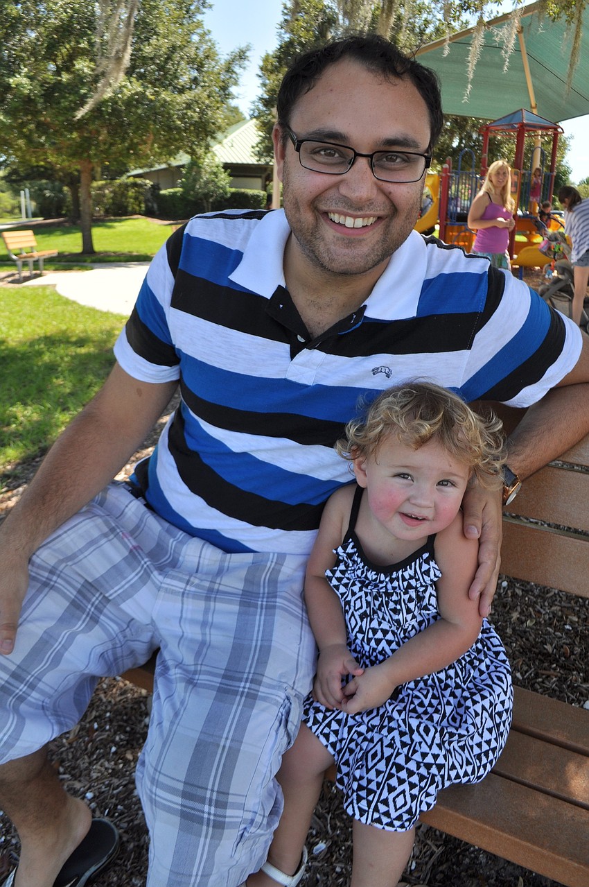 J.P. Favara and his daughter, Juliet, find a shady spot.