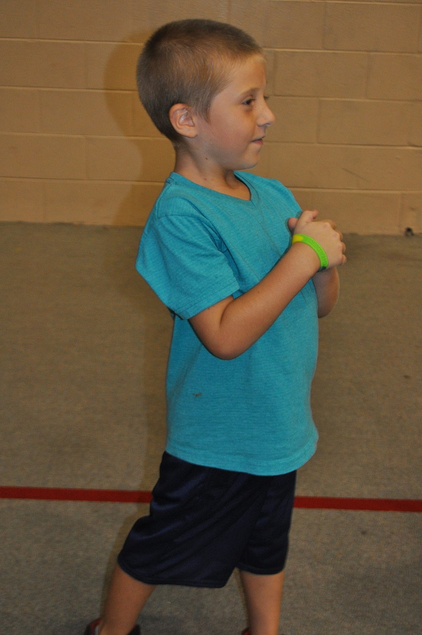 Marlowe Luggar readies for his turn shoving a giant beach ball.