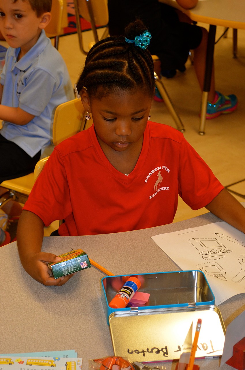 Taylor Benton focuses on her first assignment â€” coloring in a picture.