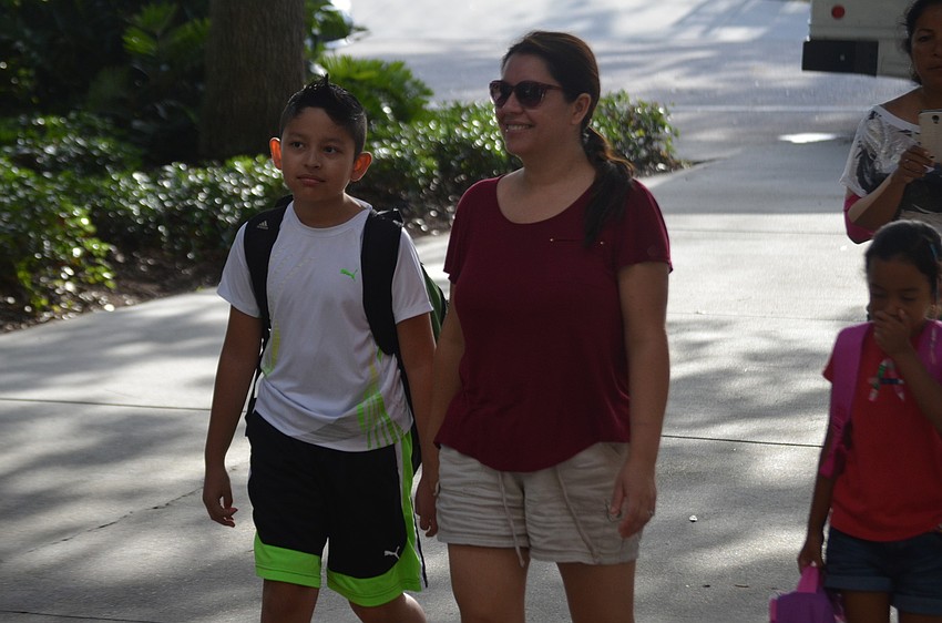 â€œIâ€™m pretty excited,â€ said Luis Lopez as he walks in to school with mom, Patricia.
