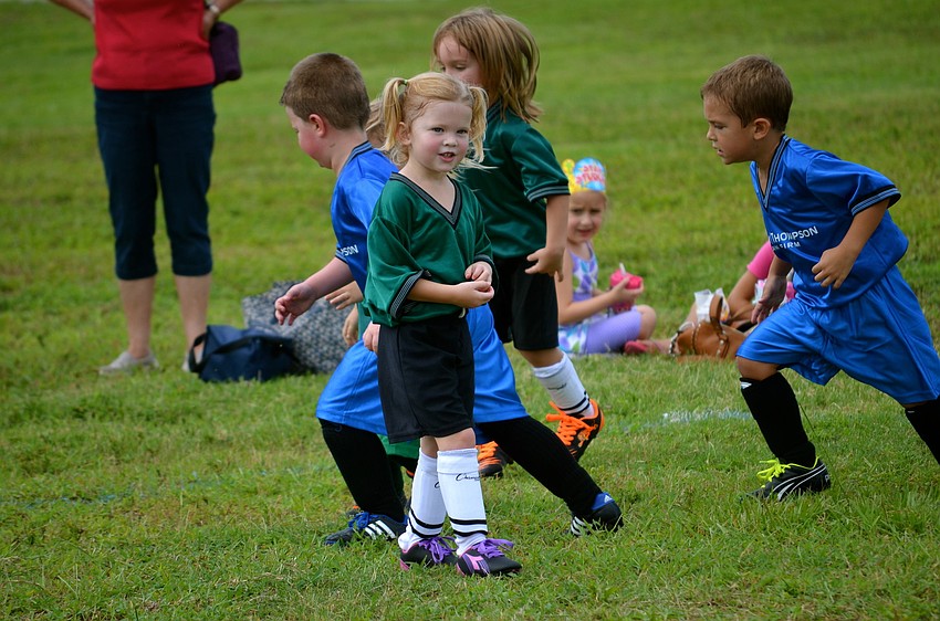Anabel O'Malley smiles at her teammates on the sidelines.