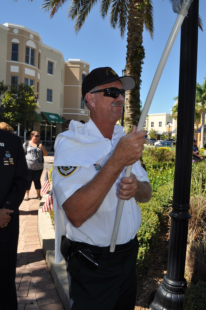 Crossing Guard Fred Fisher carries a Sept. 11, 2001, American flag.
