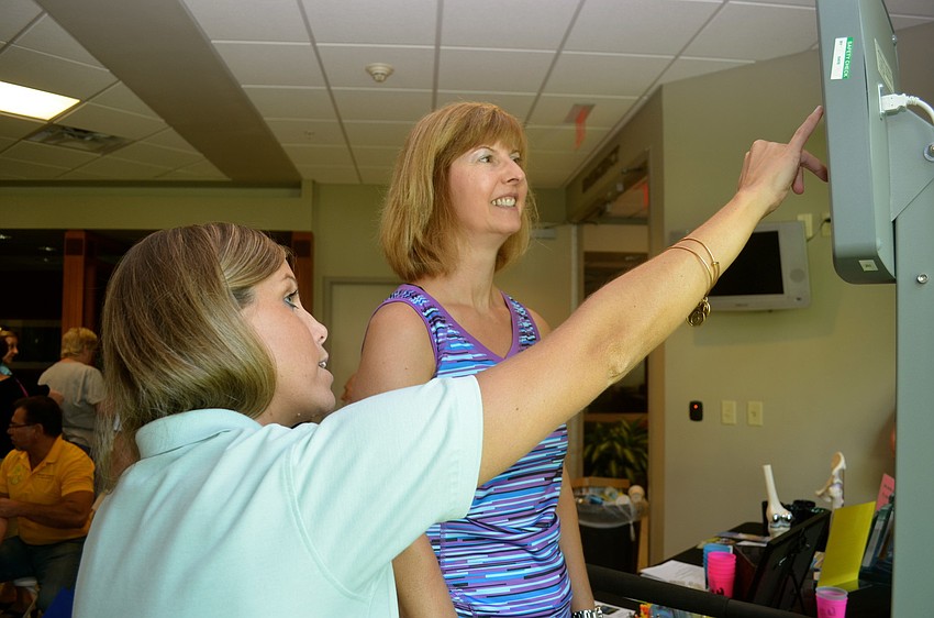 Courtney Tarpey explains the balance test to Rhonda Harrison.