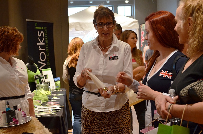 Carolyn Jacobson explains some of the products from Pure Romance to bride-to-be Leanna and her mother Geralyn.