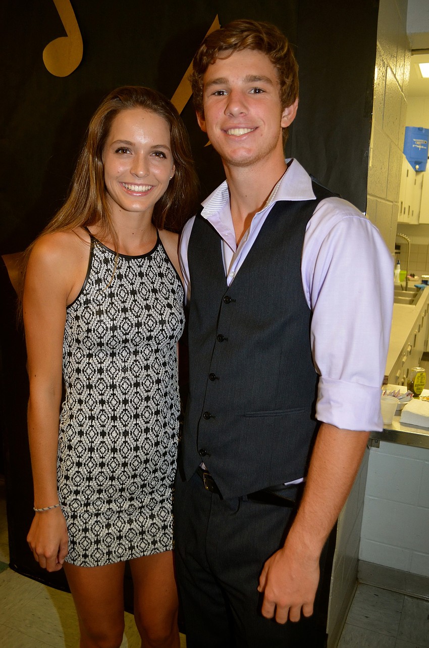 Hailey Todoroff and Jaxon Wilberding relax in the hallway before going to dance.