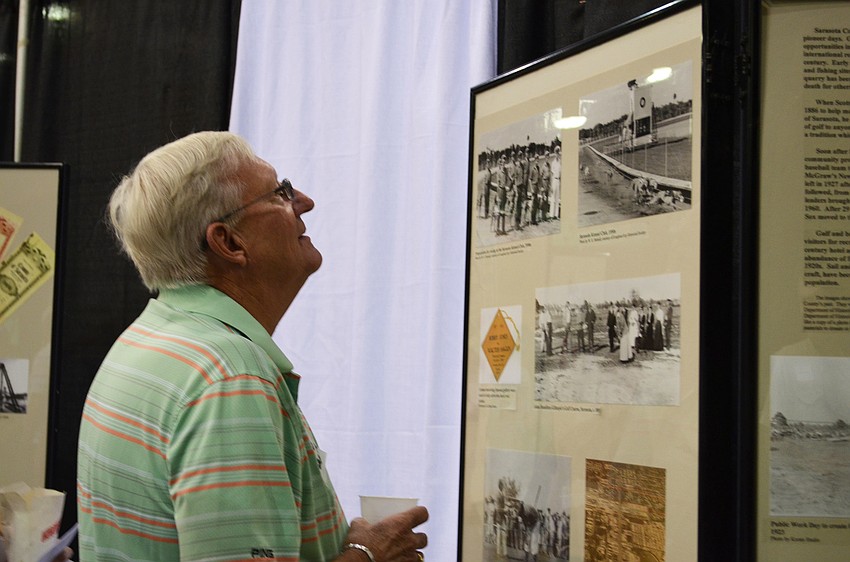 Don Gardner admires memorabilia and photos on display at the Pioneer Day Picnic.