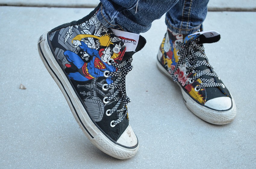 Claire Risner shows off her Superman converse sneakers.