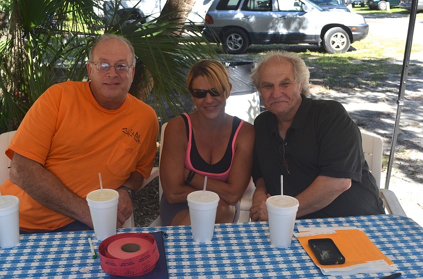 Burt Linn, Lorie Monstello and Larry Feldman welcome attendees to the event.