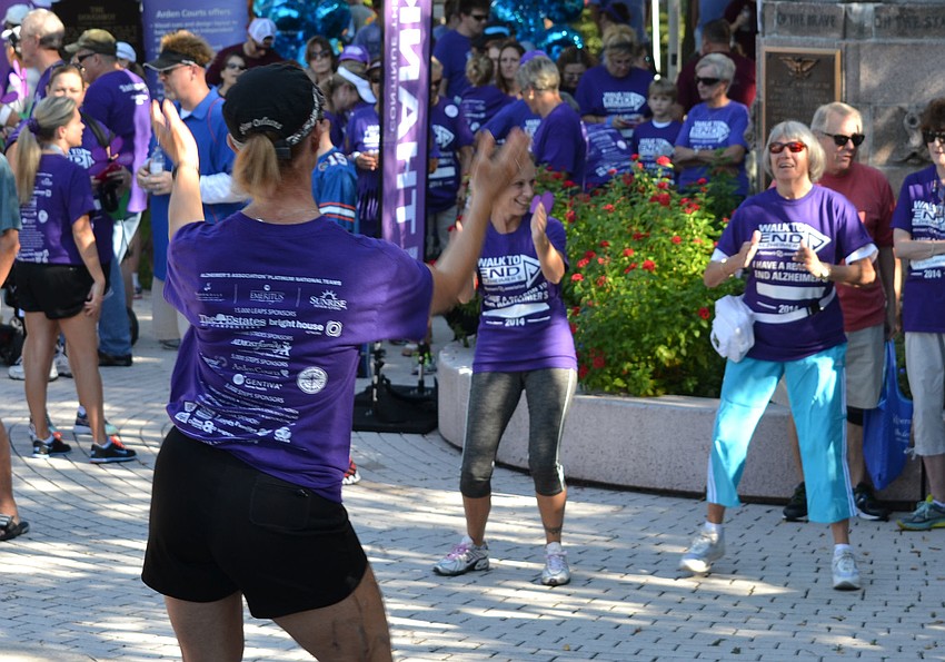Alic Monsaret leads walkers in a Zumba warm-up before the walk starts.