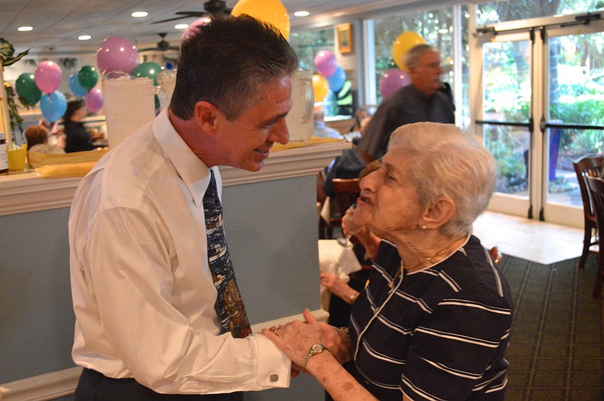 Owner Michael Garey talks with customer Bea Einstein