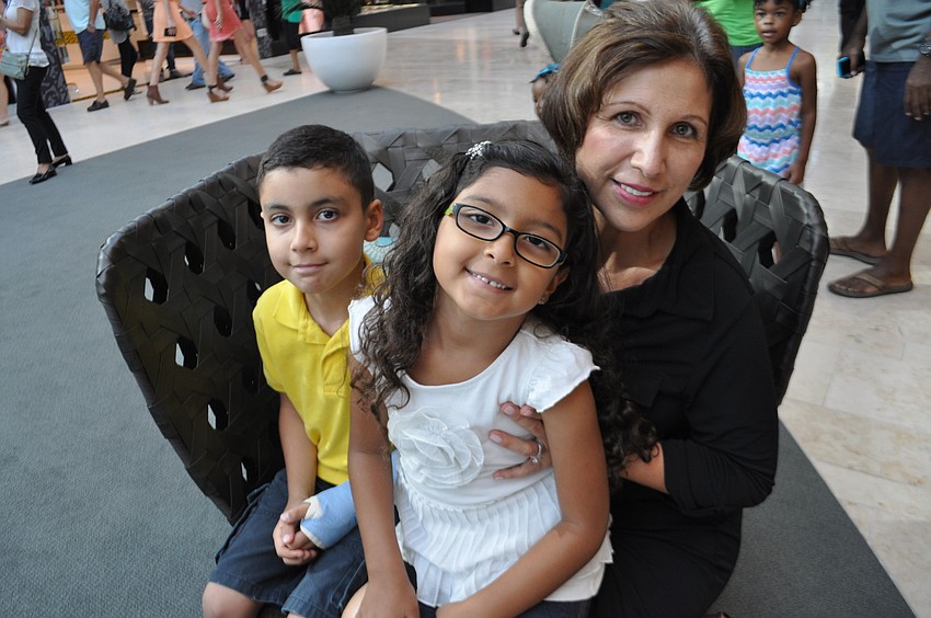 Jonathan, Rebecca and Xiomara Calle watch a juggler perform.