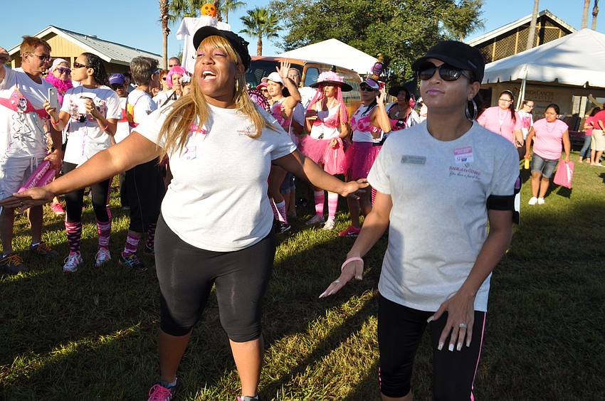 Sherkendra Burch and Jasmin Nieves stretch before the walk starts.