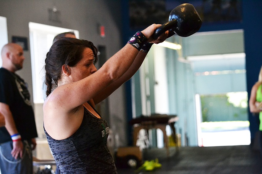 Caitlin Roper performs a Russian kettle bell swing.