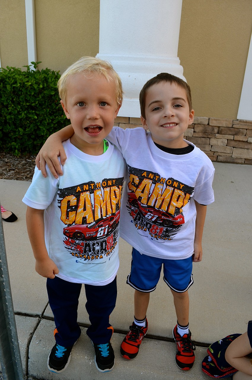 Grayson Elder and Beckett Smith show off their Anthony Campi T-shirts they received after sitting in the car.