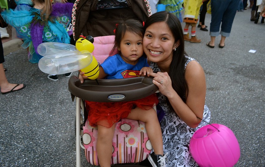 Isabella Souksengphet and her mother, Irish, enjoy trick-or-treat time.