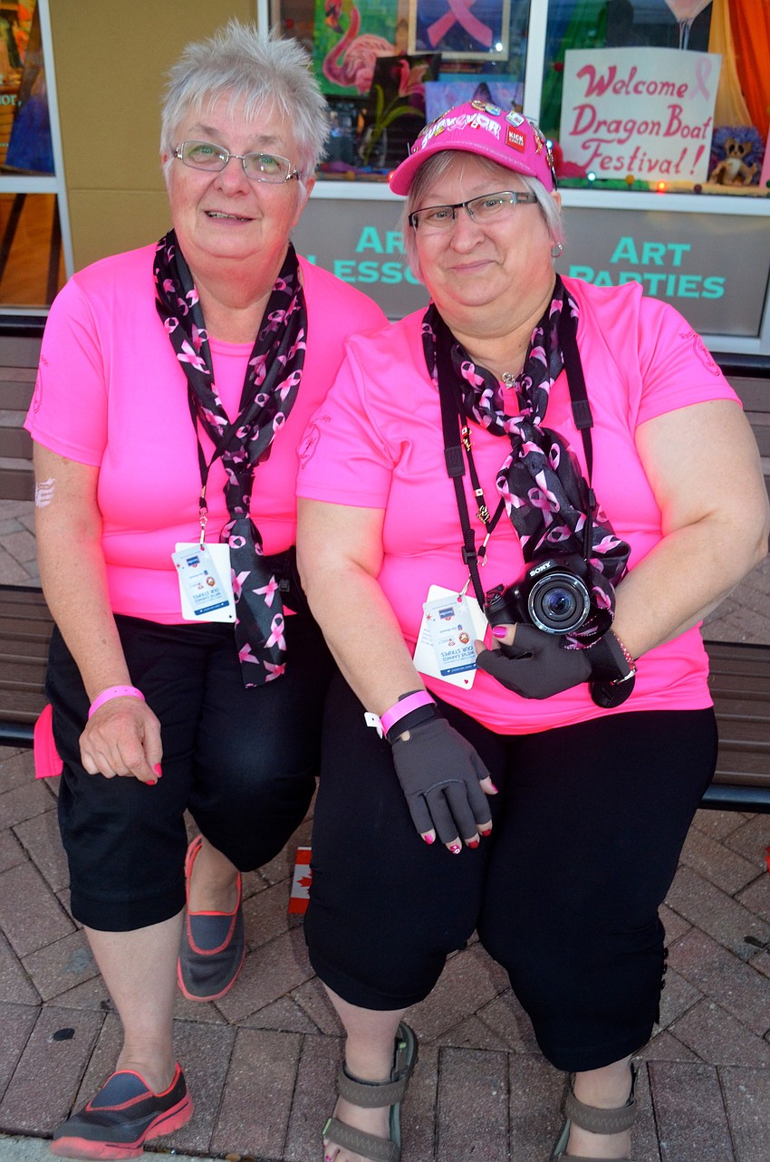 Darlene Yurchuk and Susan Klyne cheer from the sidelines.