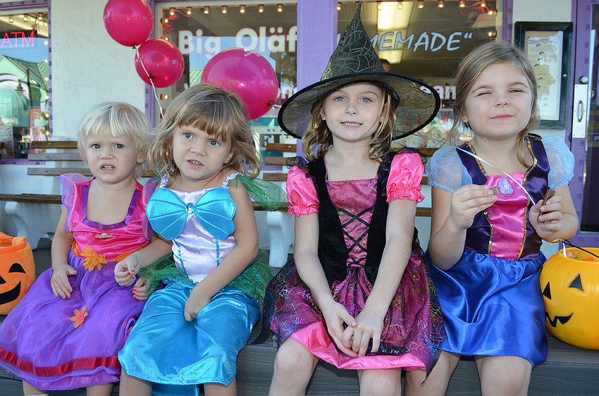 Linnea Maypole, Victoria Maypole, Dani Pfirrman and Lindsey Pfirrman take a break from walking to enjoy some candy.