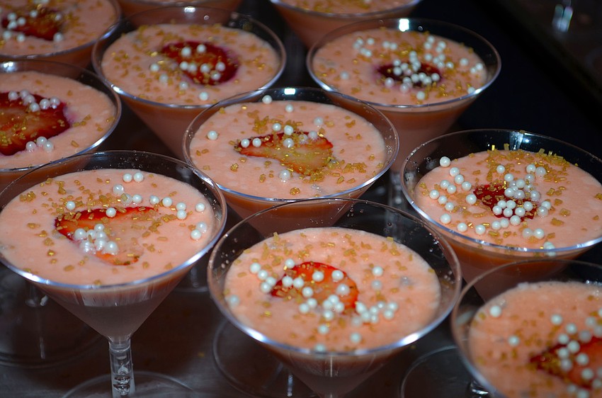 CafÃ© Americano served pink panna cotta with fresh strawberry for dessert.