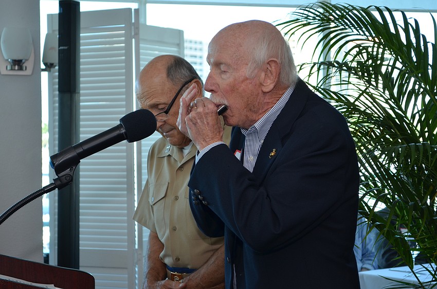 Peter Minotti played the harmonica in a moment of silence for all deceased Marines.