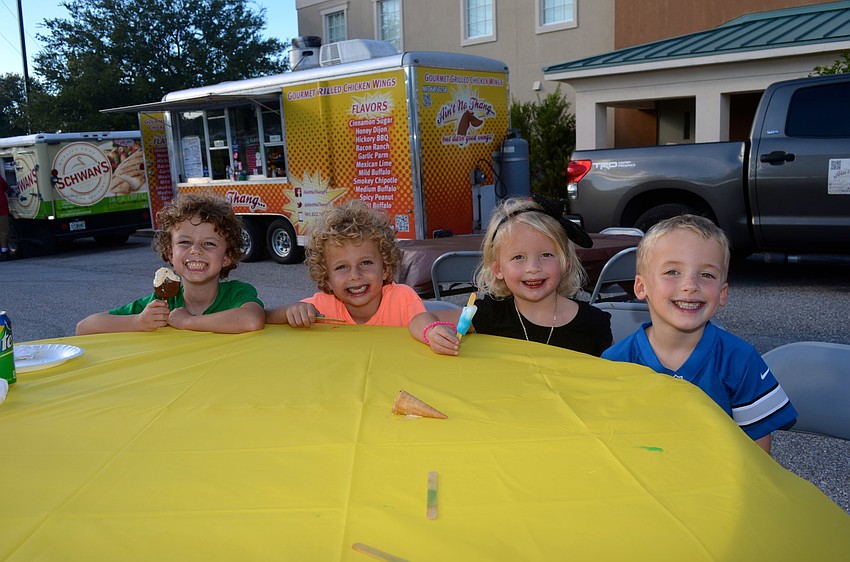 Friends Luke and Johnny Barringer and Hayden and Parker Bowles snack on frozen treats.