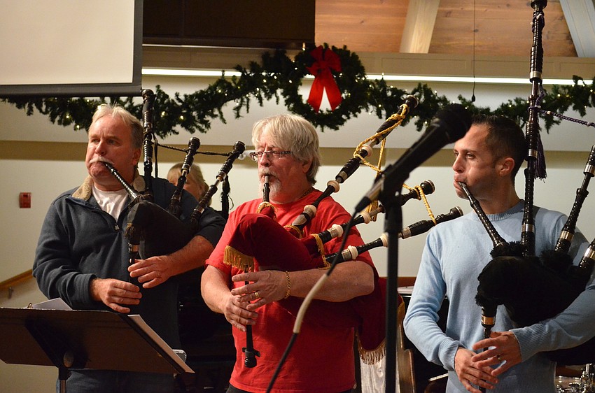 Kevin Oâ€™Neil, Larry Jacobs and Ross Allen roar on their bagpipes.