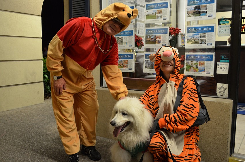Ivan and Sharon Gould dressed as Winnie the Pooh and Tigger with their dog Gellie for the Light Up The Village parade.