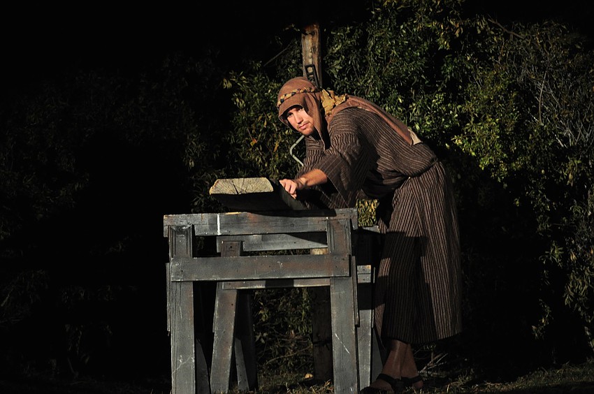 Joseph, played by Caleb Jordan, completes carpentry.