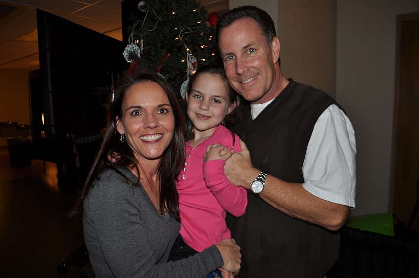 Event chairwoman Paula Carroll grabs a picture with her daughter and husband, Meredith and Irish.