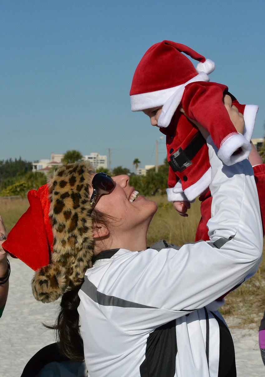 Laura Gooley and her son Max took home the title of â€œMost Adorableâ€ in the costume contest for the Sandy Claws Beach Run.