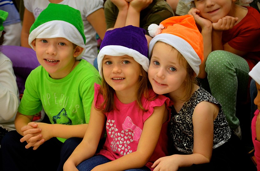 Thomas Baker, Danakah Morrell and Lillianne Dickerman sport Christmas attire.