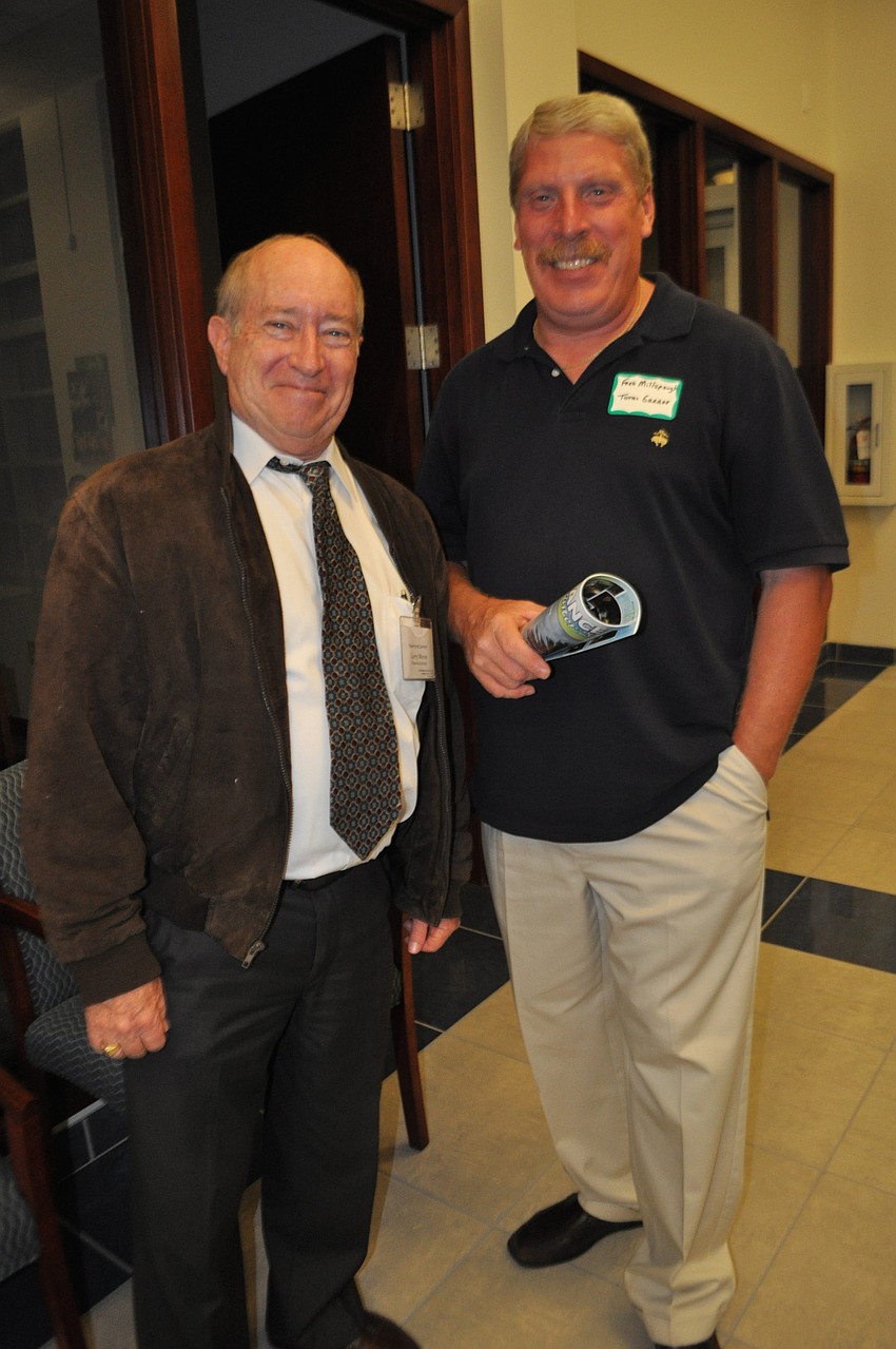 Larry Morse, of Raymond James, chats with Fred Millspaugh, of Total Garage.