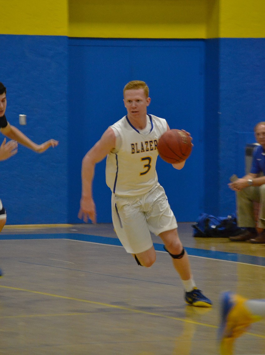 Junior Blake Morrow dribbles down the court.