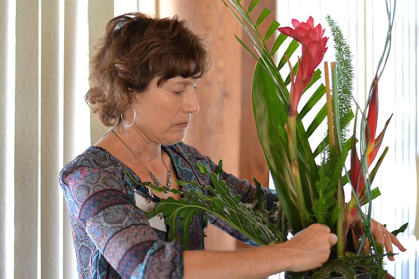 Jen Ruff adds to her floral design.