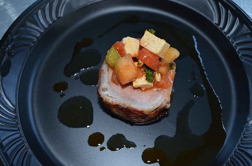 Bacon-wrapped pork loin with pickled watermelon and feta cheese, served by the Lido Beach Resort