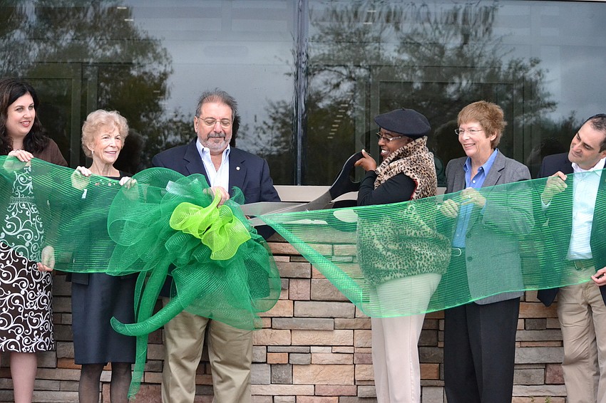 Commissioner Carolyn Mason cuts the ribbon to open the new Gulf Gate Library.