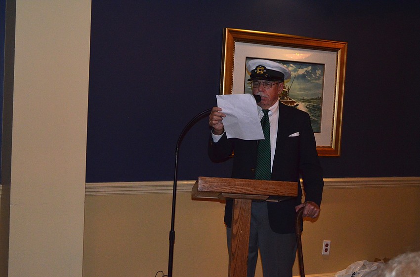 Former commodore Larry Bateman swears in the new officers.