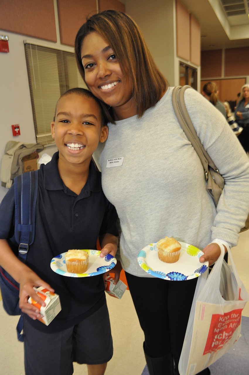 Nicholas and Nicole Bryan both select cheese muffins.