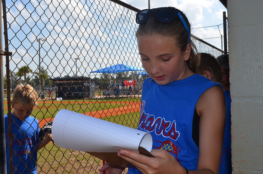 Atlanta Braves team manager, Brooke Gagg, goes over the batting order.