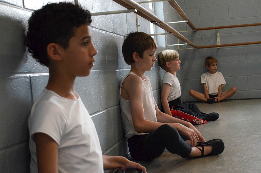 Lost Boys Tony Rutland, Kimbell Cockrell, Frankie Duffy and Wilhelm Cockrell stretch before a Sarasota Ballet School â€œPeter Panâ€ rehearsal