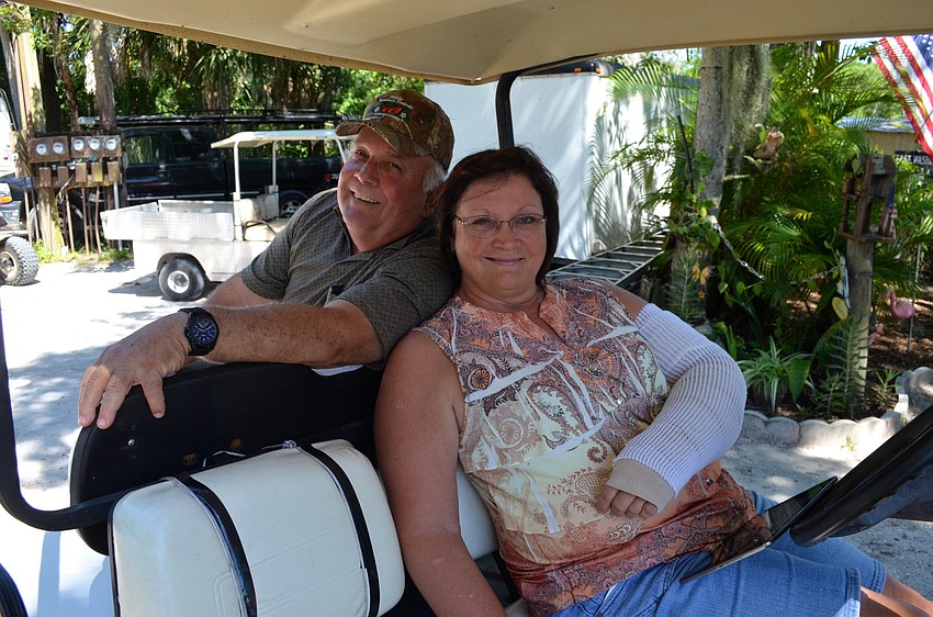 Terry Clark and Darlene Bass enjoy the music from the shaded of their golf cart.
