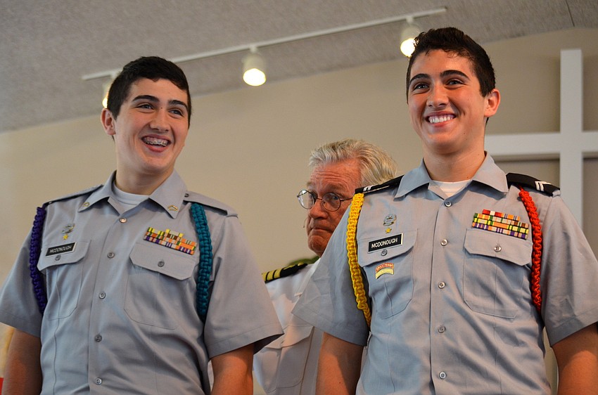 The Rev. Vincent Carroll introduces brothers Michael and David McDonough, who participated in the service, to the congregation.