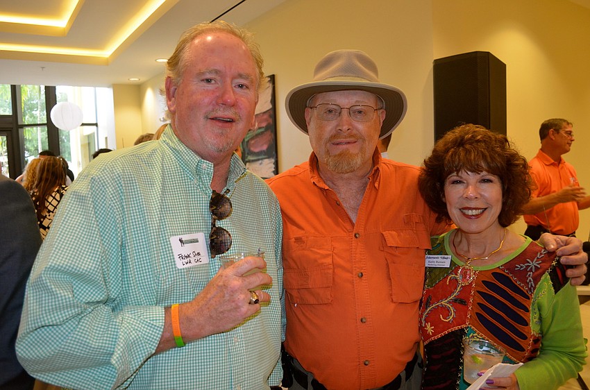Frank Shea and Steve and Kathy Burnam enjoy drinks at the reception.