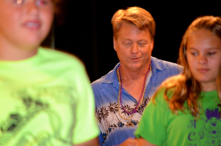 Fifth-grade instructor Steven Pippins dances with his students.