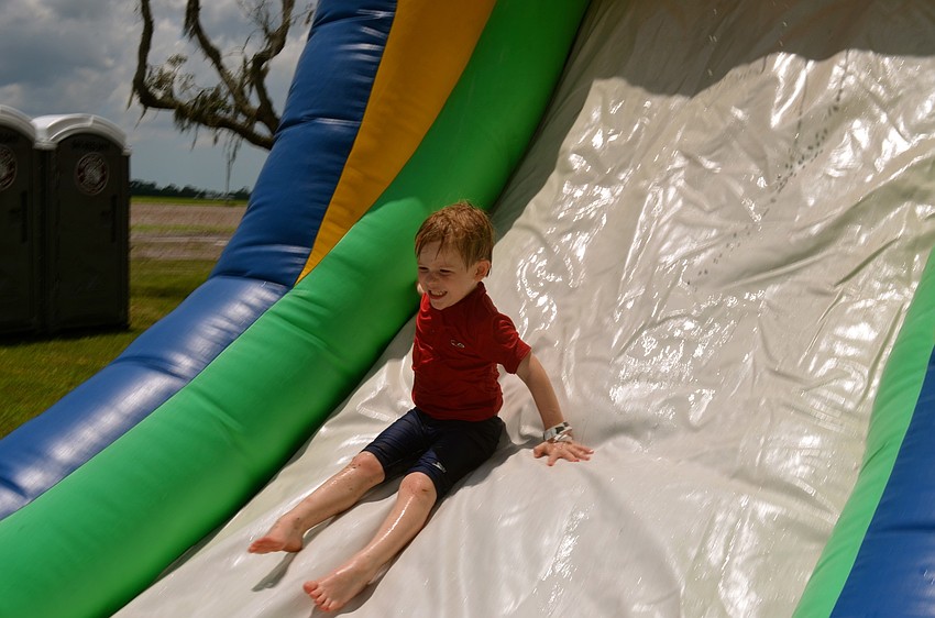 Enzo Zane Mitchell cools down on a water slide.