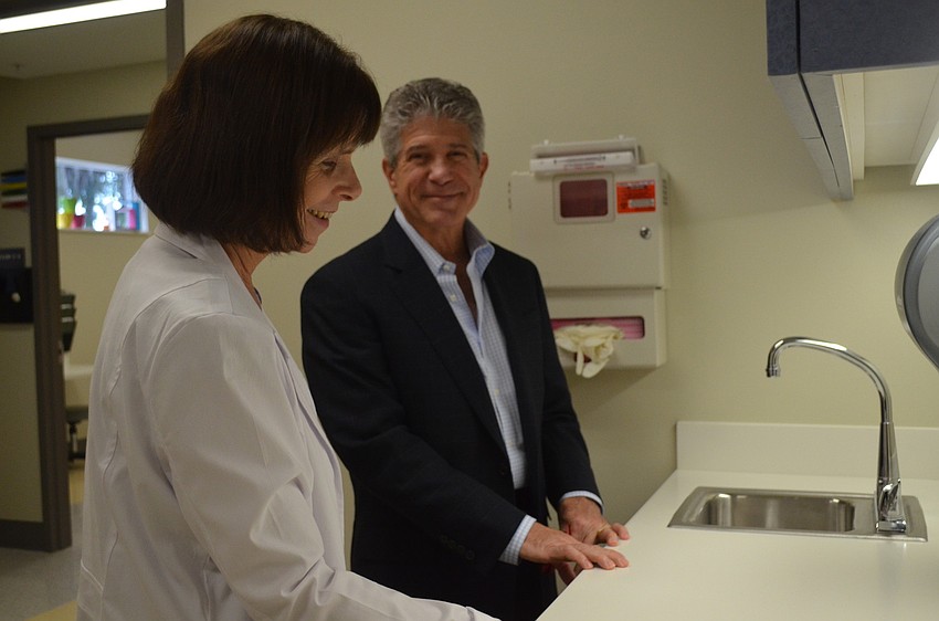 Dr. Francine Gross gives Tom Shapiro a tour. 