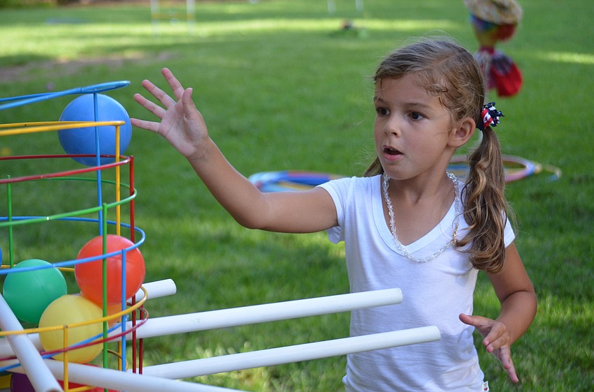 Reagan Gillece plays in the lawn.