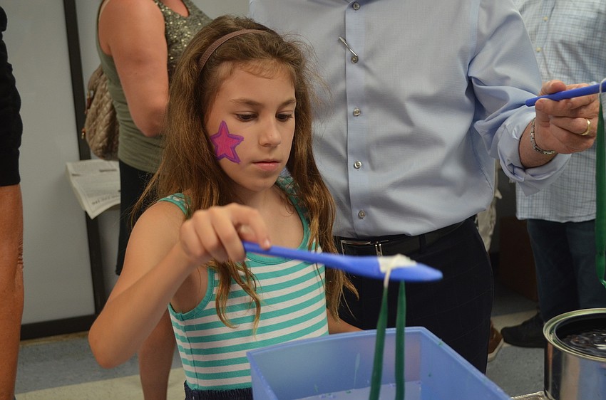 Abbie Mount dips her candle.