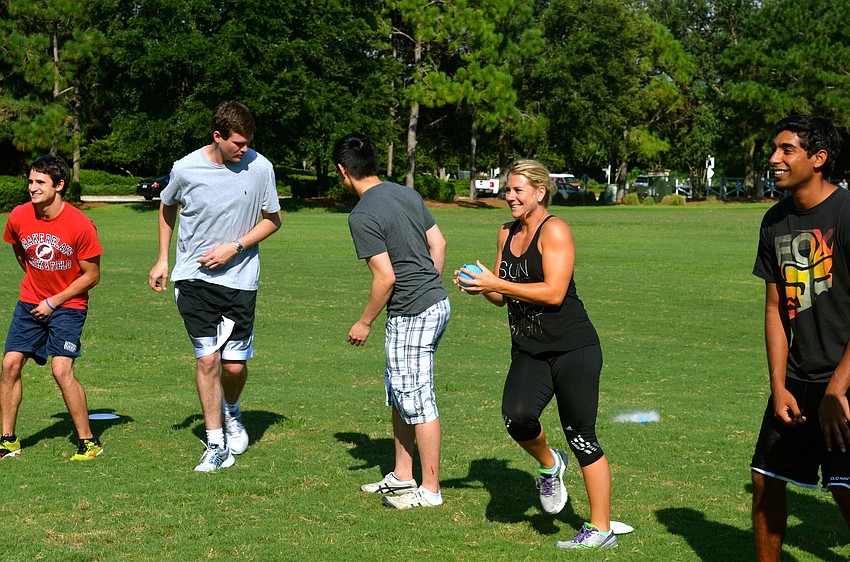 Brittney Russell and her team sprint toward the other team during  water balloon dodgeball.