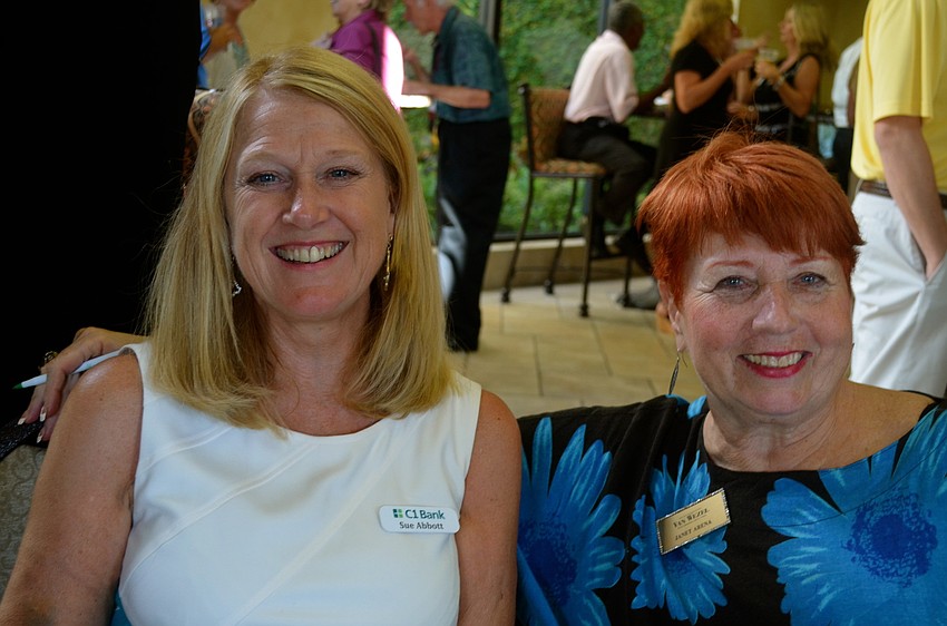 Door greeters Sue Abbott and Janet Arena enjoy the evening.